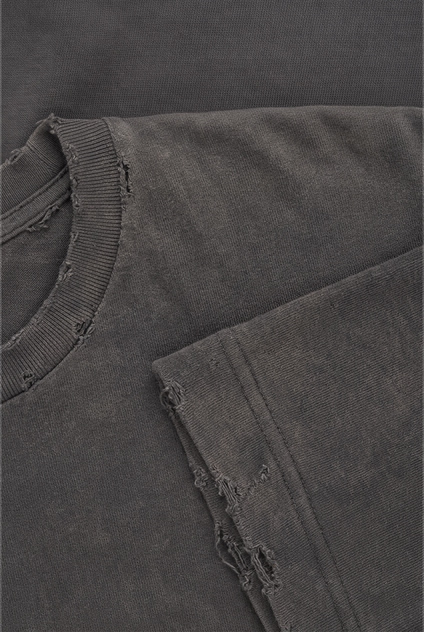 Close-up of the distressed hem of a washed charcoal sweatshirt
